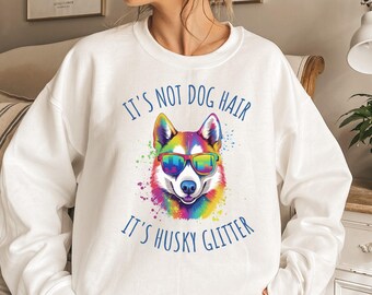 May include: White sweatshirt with a colorful husky dog wearing sunglasses and the text "It's not dog hair, it's husky glitter."