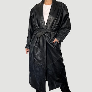 May include: A long black leather coat with a belt and a shawl collar.