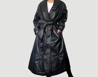 May include: A long black leather trench coat with a belt and a collar.