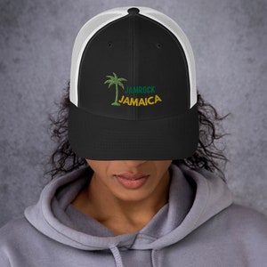 May include: Black and white trucker hat with a green palm tree and the text "Jamrock Jamaica" embroidered on the front.