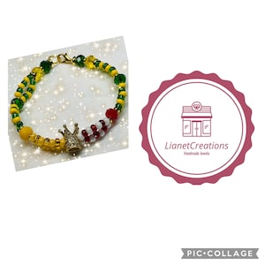 May include: A beaded bracelet with a gold crown charm. The bracelet is made with green, yellow, red, and white beads.