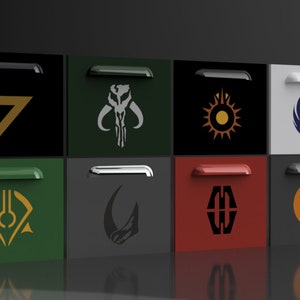May include: Eight square drawer fronts with different coloured backgrounds and various Star Wars themed logos. The logos include the Mandalorian symbol, the Rebel Alliance symbol, the Empire symbol, and the symbol for the First Order.