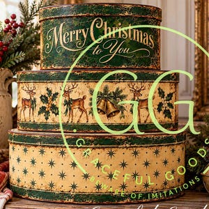 May include: A set of three stacked round metal tins with a distressed finish. The top tin is green with the text Merry Christmas to You. The middle tin features reindeer and holly illustrations. The bottom tin has a cream background with green stars.