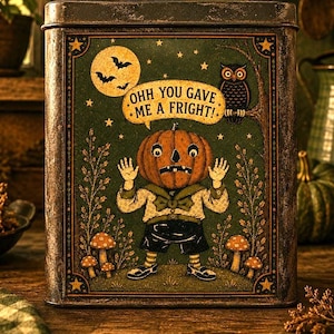 May include: A rectangular metal tin featuring a vintage-style illustration of a pumpkin-headed character with the text OHH YOU GAVE ME A FRIGHT! The scene includes a full moon, bats, an owl, and mushrooms against a dark green background.