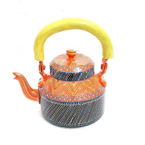 May include: An orange teapot with a yellow handle and detailed geometric patterns in blue, yellow, and white. The teapot has a spout and a lid with a small knob. The design is painted on the body of the teapot.