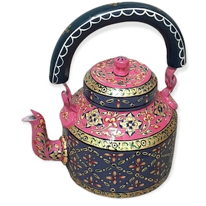 May include: A hand-painted, decorative teapot with a pink and gray floral design. The teapot features a dark green handle with white scalloped trim and a pink spout. Gold accents highlight the floral patterns and edges, creating a vibrant and ornate appearance.