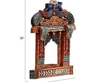 May include: Hand-carved wooden wall decor, 18 inches high, 12 inches wide, and 3 inches deep. The frame is painted in shades of orange, blue, and black, featuring intricate floral and peacock designs. The top has two carved peacocks.