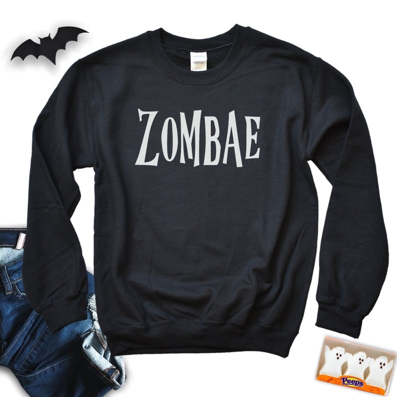 May include: Black sweatshirt with the text "ZOMBAE" in white lettering.