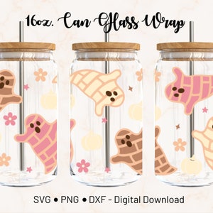 May include: Three clear glass can wraps with wooden lids and stainless steel straws. Each wrap features a repeating pattern of cartoon ghosts in shades of brown, pink, and cream, along with pumpkins, flowers, and stars. The text "16oz. Can Glass Wrap" is at the top.