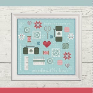 May include: A cross stitch pattern featuring a variety of sewing and crafting tools, including scissors, needles, thread, buttons, and fabric. The pattern is framed in a white frame and has a light blue background. The text "Made with Love" is included in the pattern.