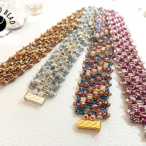 May include: Four beaded bracelets in different color combinations, including gold, silver, teal, and pink. Each bracelet has a unique pattern and is finished with a clasp.