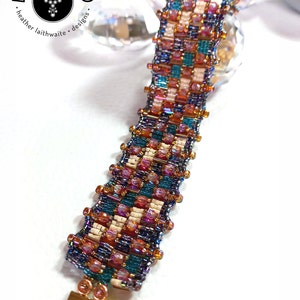 May include: A beaded bracelet with a geometric pattern in shades of teal, purple, pink, and cream. The bracelet has a gold clasp.