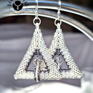 May include: Silver-toned beaded triangle earrings. The earrings are made of small, shiny beads in shades of silver and black, forming a geometric triangular shape. The earrings have a dangling design with a small crystal accent.