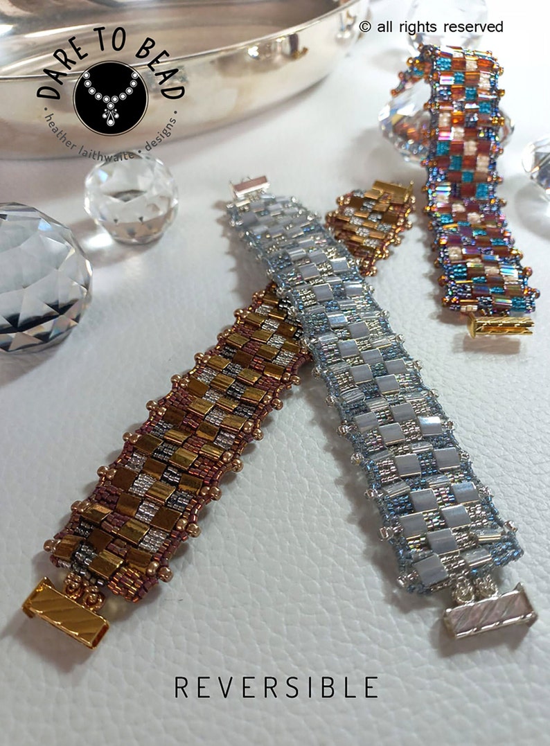 May include: Three reversible beaded bracelets with a checkered pattern. The bracelets are in shades of silver, gold, and brown. The bracelets are on a white surface with the text "REVERSIBLE" below them.