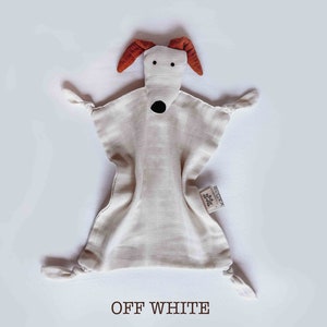 May include: Off-white muslin baby security blanket with a dog face and brown ears. The blanket has knotted corners and a small tag that says "REDOMA".