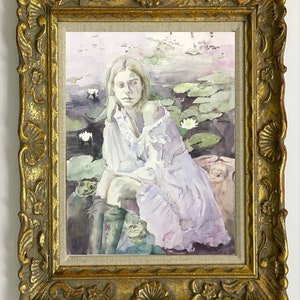 May include: A framed watercolor painting featuring a woman seated among lily pads. The woman wears a white blouse and a light purple dress. The painting is in a gold ornate frame.