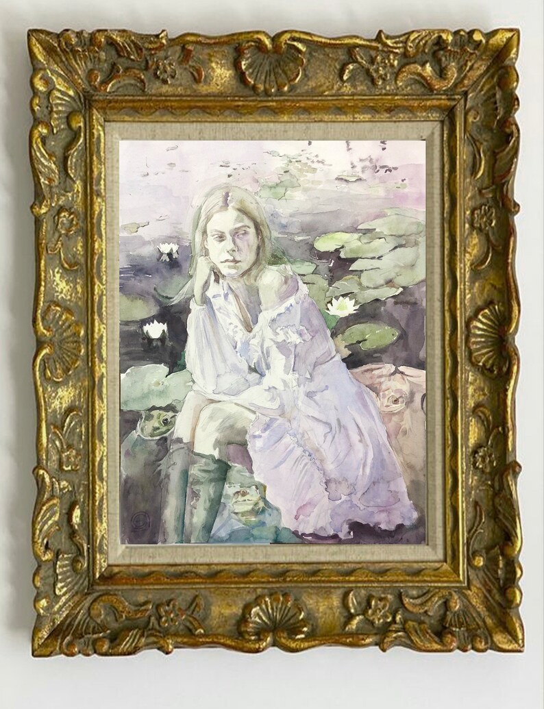 May include: A framed watercolor painting featuring a woman seated among lily pads. The woman wears a white blouse and a light purple dress. The painting is in a gold ornate frame.