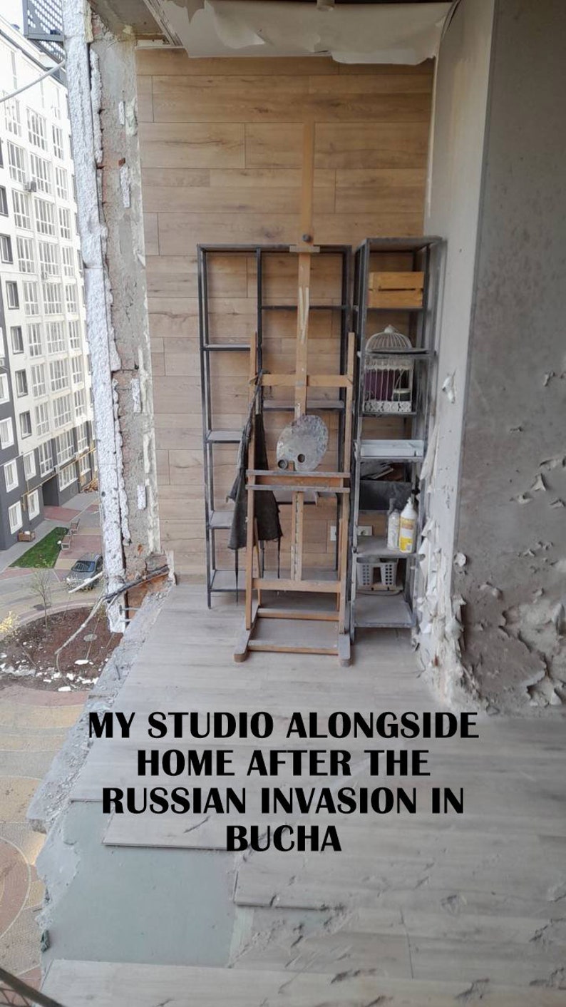 May include: An artist's studio on a balcony, featuring a wooden easel, a metal shelving unit, and a birdcage. The text "MY STUDIO ALONGSIDE HOME AFTER THE RUSSIAN INVASION IN BUCHA" is visible. The balcony shows signs of damage.
