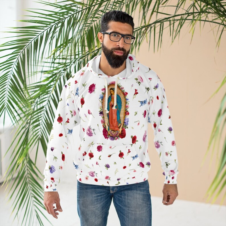 May include: White hoodie with a floral pattern and a picture of the Virgin Mary in the center. The hoodie has a drawstring hood and a kangaroo pocket.