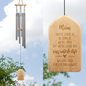 May include: A wooden wind chime with a beige finish and a message engraved on the bottom plaque. The message reads "Mom You've loved us as long as we've lived but we've loved you our whole life We love you! Forever and always".