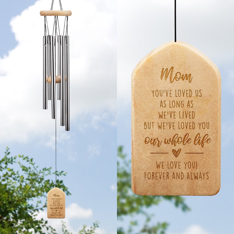 May include: A wooden wind chime with a beige finish and a message engraved on the bottom plaque. The message reads "Mom You've loved us as long as we've lived but we've loved you our whole life We love you! Forever and always".