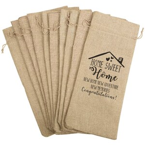 May include: A set of 10 burlap wine bags with a drawstring closure. The bags are printed with the text "Home Sweet Home" and "New Home New Adventure New Memories Congratulations!"