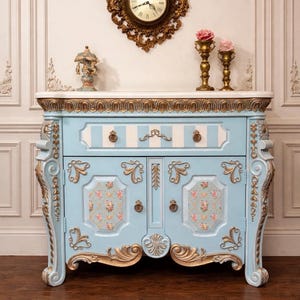 May include: A set of three ceramic mugs with a speckled, matte finish. The mugs are in shades of cream, light gray, and dark gray. Each mug has a simple, minimalist design, perfect for coffee or tea.