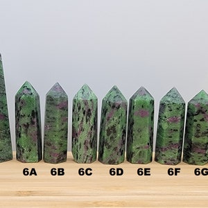 May include: Ten green and pink zoisite crystal points of varying sizes, labeled 8B, 6A, 6B, 6C, 6D, 6E, 6F, 6G, and 6H.