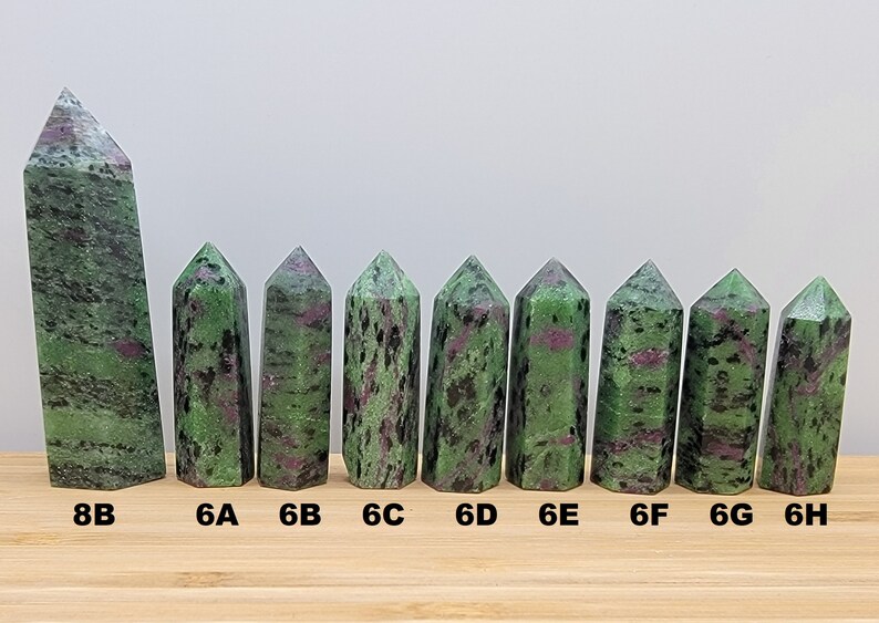 May include: Ten green and pink zoisite crystal points of varying sizes, labeled 8B, 6A, 6B, 6C, 6D, 6E, 6F, 6G, and 6H.