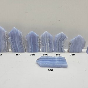 Line up picture of Blue Lace Agate Crystal Towers all with beautiful characteristics to all of them 39A 38A 36A 35A 35B 35C 35D 27  Use these numbers and letters to choose the tower you want