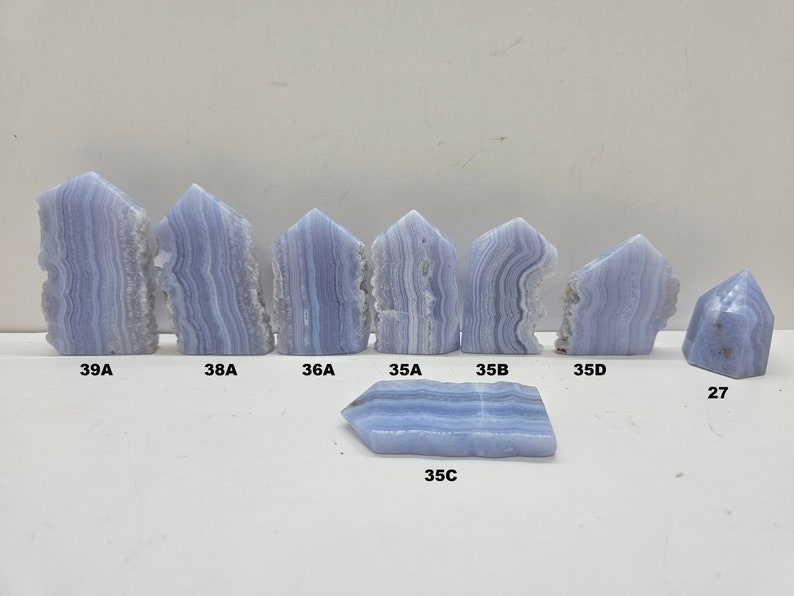 Line up picture of Blue Lace Agate Crystal Towers all with beautiful characteristics to all of them 39A 38A 36A 35A 35B 35C 35D 27  Use these numbers and letters to choose the tower you want