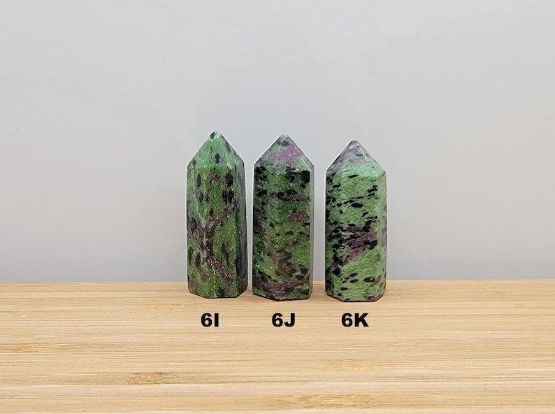 May include: Three green, black, and pink zoisite crystal points, labeled 6I, 6J, and 6K.