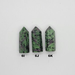 May include: Three green and black gemstone points, labeled 6I, 6J, and 6K.