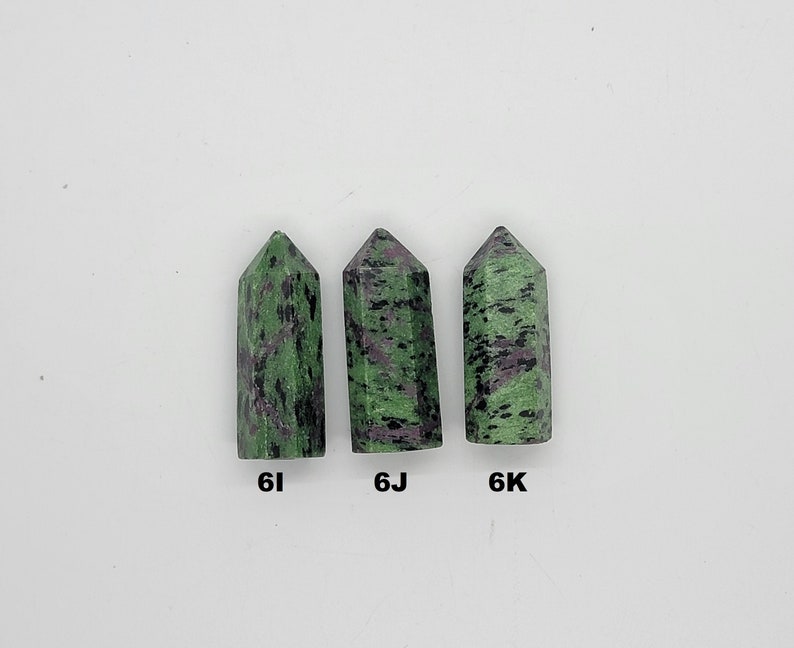 May include: Three green and black gemstone points, labeled 6I, 6J, and 6K.
