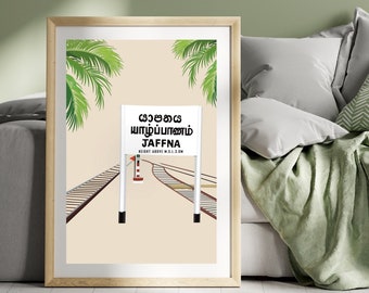 May include: A vintage-style illustration of a train track with a sign that reads "Jaffna" in Tamil and English. The sign is on a white post with a red and white striped signal light. The track is surrounded by palm trees.