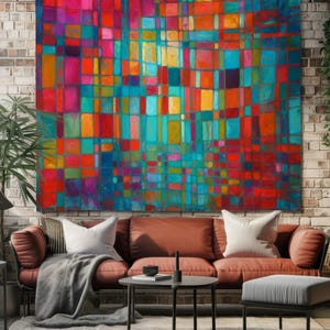 May include: Large abstract wall art featuring a vibrant mosaic of colorful squares in shades of red, orange, teal, and yellow. The artwork is displayed on a brick wall above a rust-colored sofa with white pillows. The room has a modern, artistic vibe.