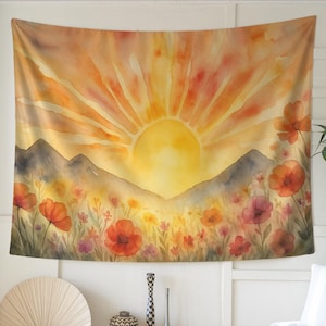 May include: A watercolor tapestry featuring a vibrant sunset scene. The artwork depicts a large yellow sun radiating light over a mountain range and a field of colorful flowers in shades of red, orange, and purple. The overall theme is nature and landscape.