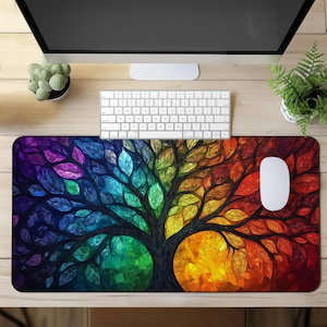 May include: A colorful stained glass style mousepad featuring a tree with rainbow leaves. The tree is set against a dark background with hints of red, orange, yellow, green, blue, and purple.