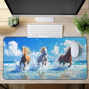 May include: A blue and white mouse mat featuring a design of three horses running through ocean waves. The horses are brown, white, and brown and white.