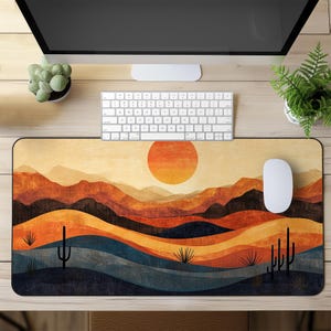 May include: A desert landscape with a setting sun, mountains, and cacti. The design is in shades of orange, brown, blue, and green. This is a mouse mat.