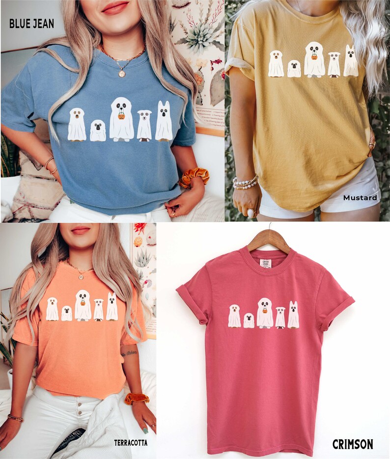 May include: Five white ghost dogs wearing Halloween costumes with a pumpkin bucket. The ghosts are printed on a t-shirt in four different colors: blue jean, mustard, terracotta, and crimson.