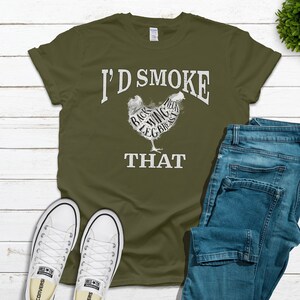May include: A green t-shirt with the text "I'd Smoke That" and a graphic of a chicken with the different parts labeled.