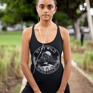 May include: A black tank top with a white graphic print of a mountain range, a moon, and the text "Stay Wild Moon Child".