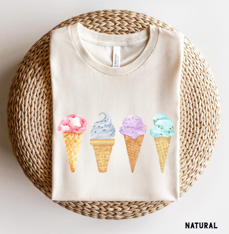 May include: A white t-shirt with a graphic of four ice cream cones in different colors and flavors. The ice cream cones are arranged in a row from left to right. The ice cream flavors are pink, gray, purple, and blue.