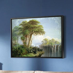 May include: A light wood sofa with two cushions and a framed painting of a waterfall and trees hanging on a blue wall above it.