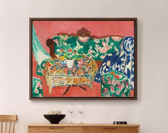May include: A painting of a colorful, patterned couch and table in a room with a pink wall. The couch is green and blue with floral patterns. The table is covered in a red and white patterned tablecloth. There is a white cup and saucer on the table.