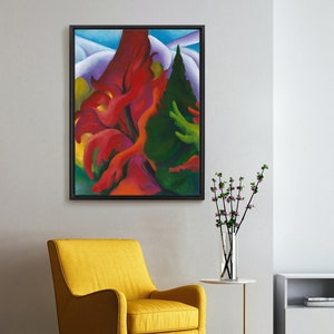 May include: A framed abstract painting with a black frame. The artwork features vibrant red, green, and yellow shapes against a blue and white background. A yellow armchair with black legs sits below the painting, adding a pop of color to the room.