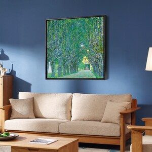 May include: A framed painting of a green tree-lined path leading to a yellow building. The painting is in a pointillist style, with small dots of color creating the image.