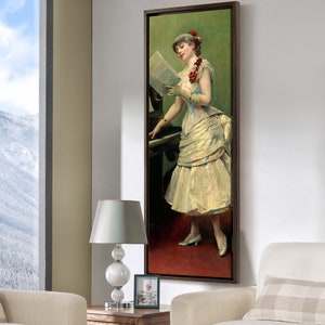 May include: A painting of a woman in a white dress standing at a piano, holding a sheet of music. She is wearing a floral headband and a white glove. The painting is framed in a dark wood frame.