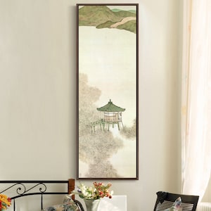May include: A framed painting of a traditional Asian-style pavilion with a green roof, set against a backdrop of mountains and water. The painting is done in a minimalist style with muted colors and delicate brushstrokes.